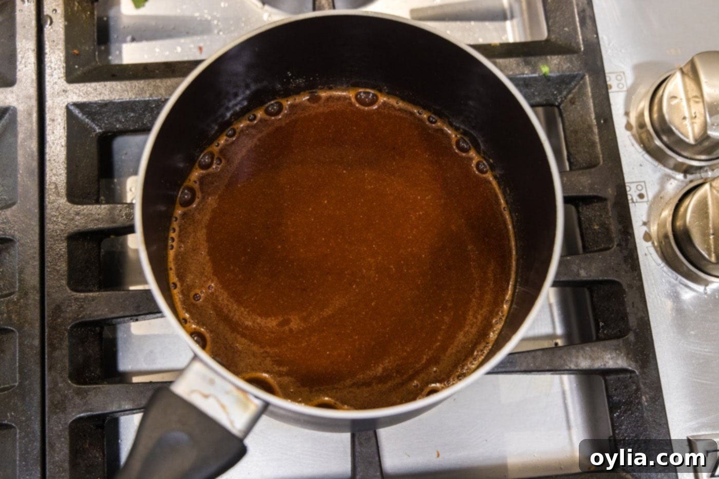 dr. pepper barbecue sauce cooking on the stovetop at a gentle boil