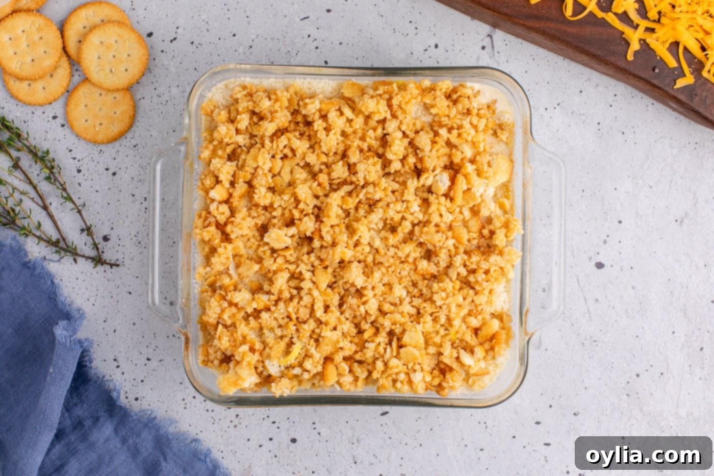 squash casserole topped with a generous layer of buttery Ritz crackers, ready for baking