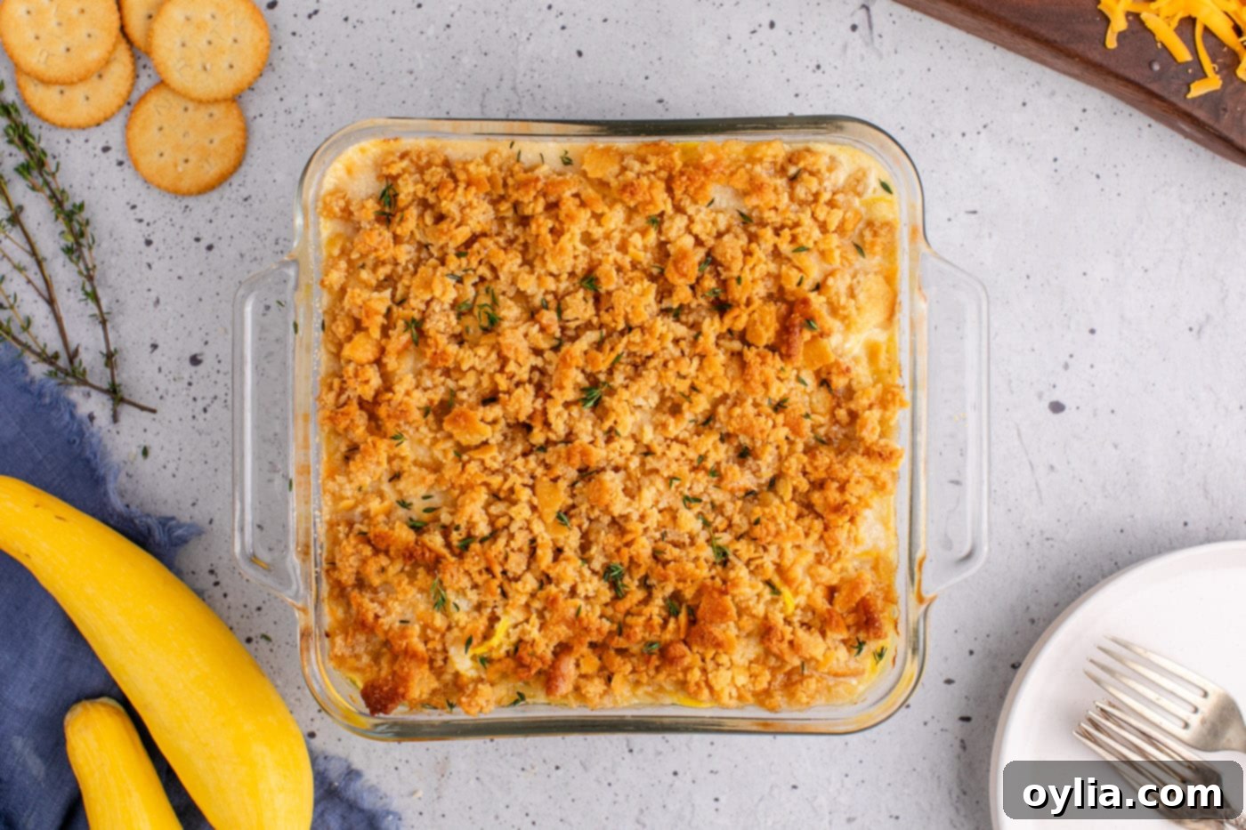 baked summer squash casserole, golden and bubbling, garnished with fresh thyme