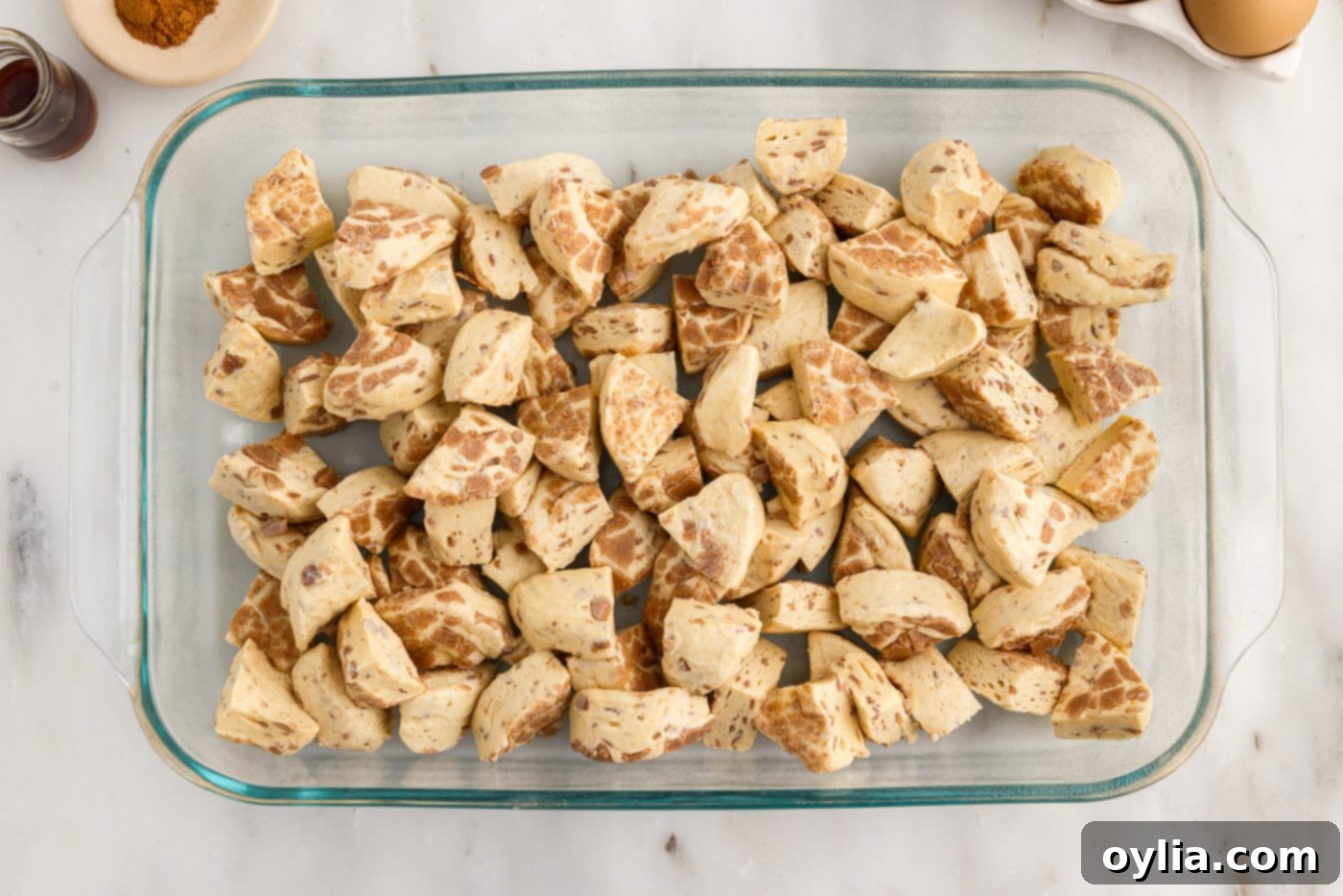 quartered cinnamon rolls in a baking dish