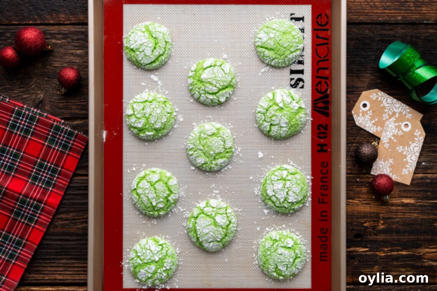 Freshly baked Grinch cookies on a baking sheet, just removed from the oven and perfectly puffed.
