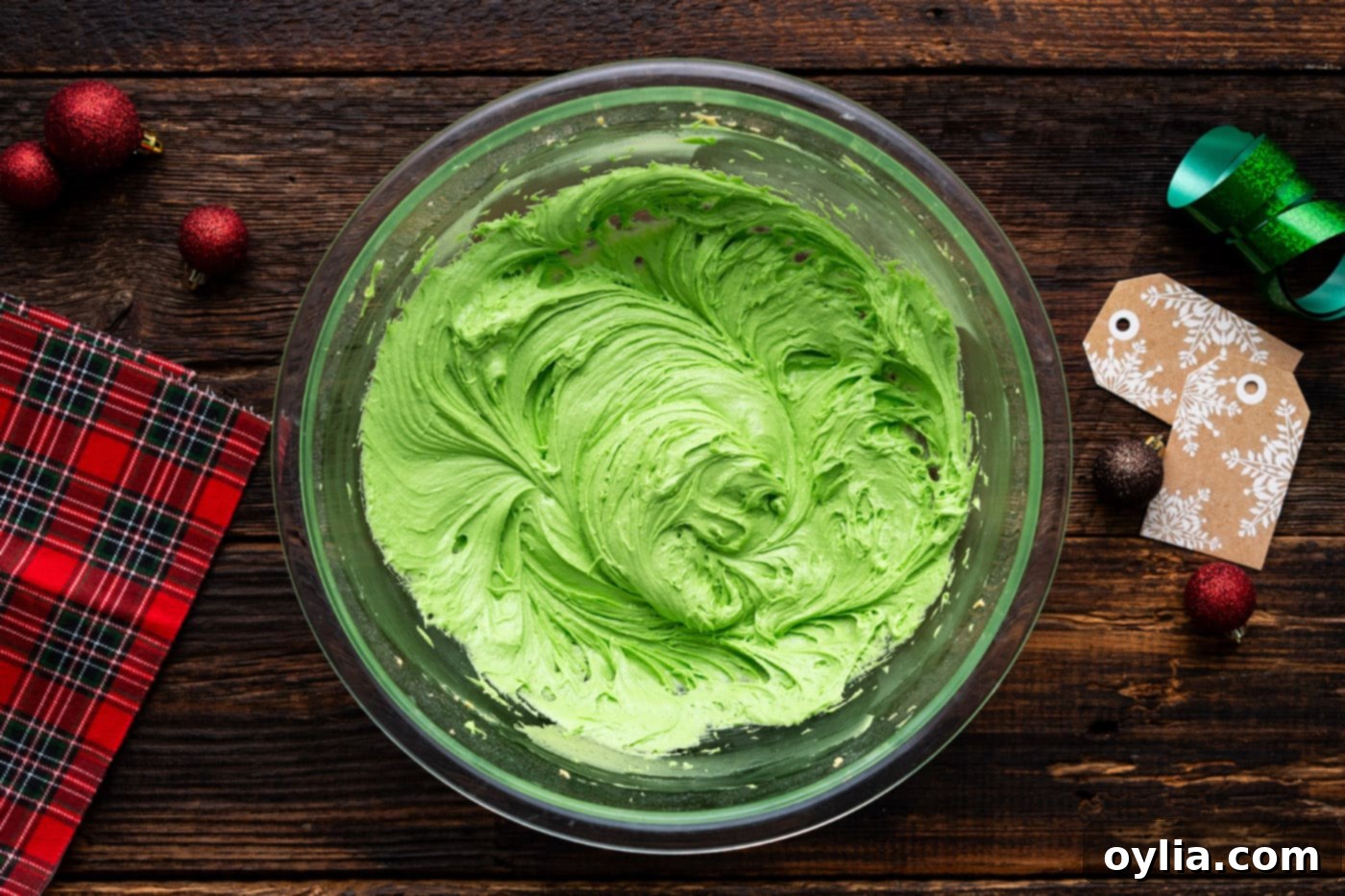 Vibrant green Grinch cookie dough in a mixing bowl, perfectly colored and ready for the next step.