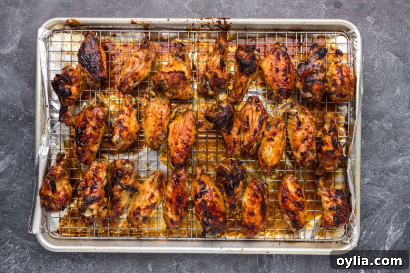 honey garlic coated wings on a baking sheet