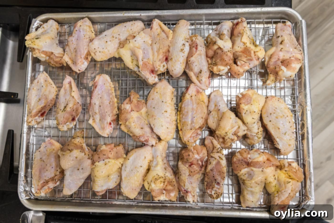 raw chicken wings on a baking sheet