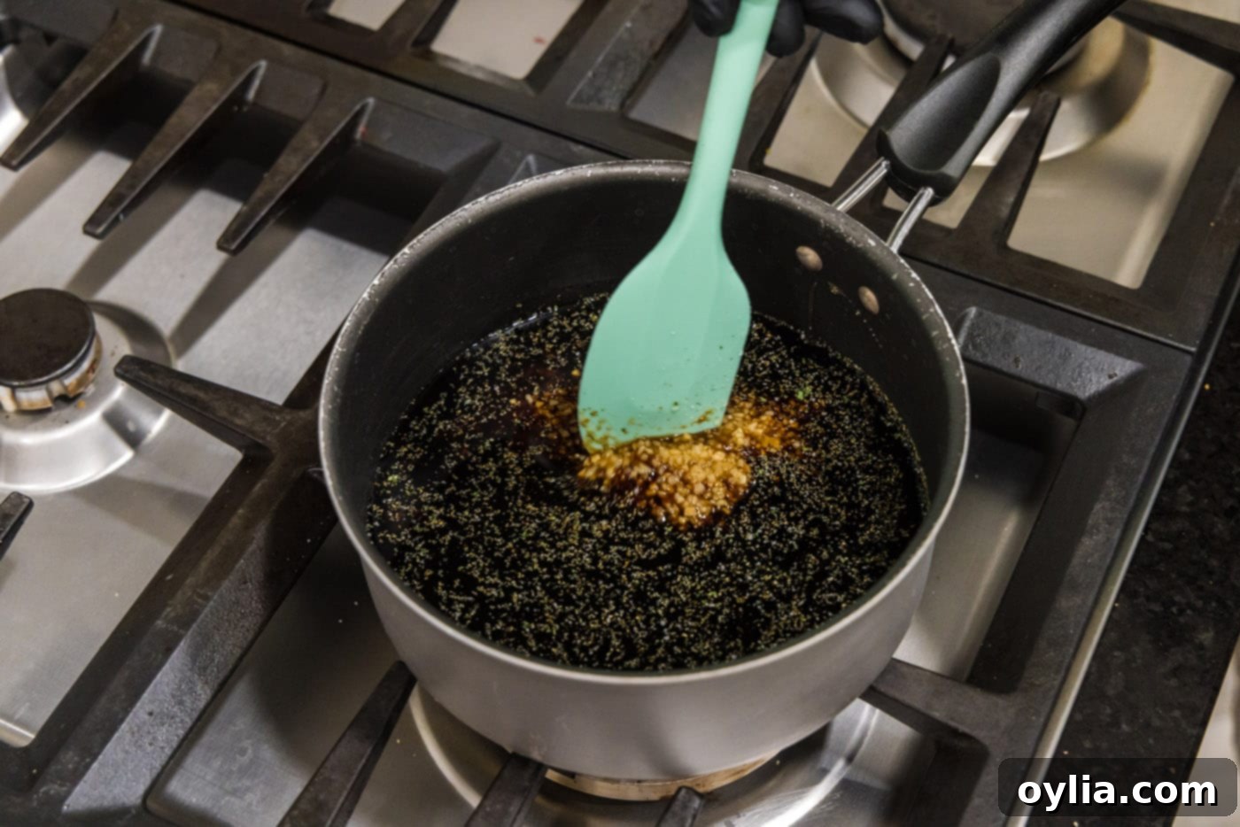 stirring honey garlic sauce in a saucepan