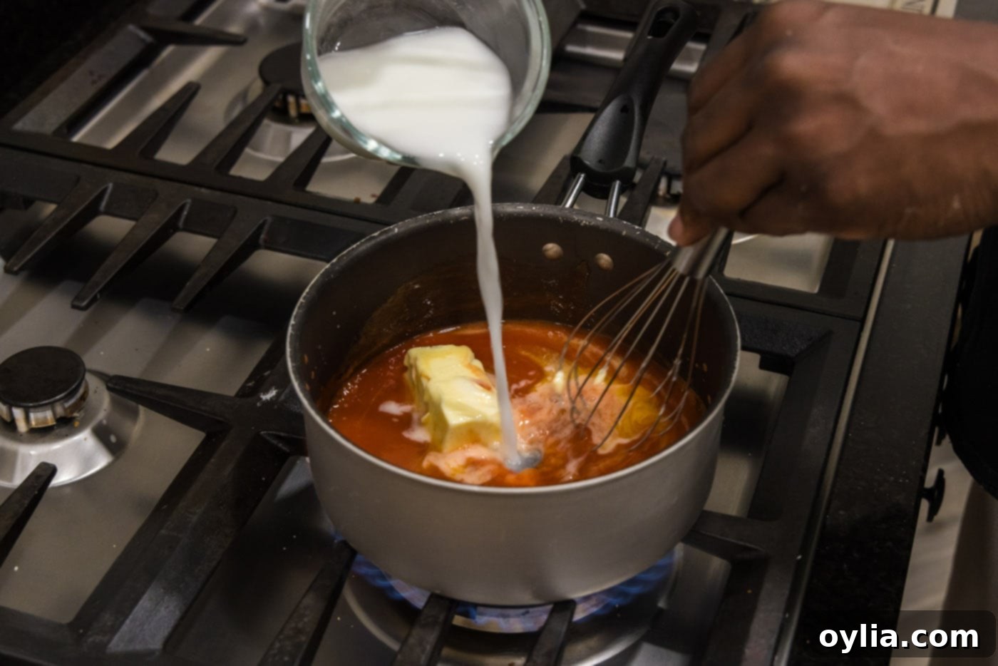 whisking a cornstarch slurry into buffalo sauce