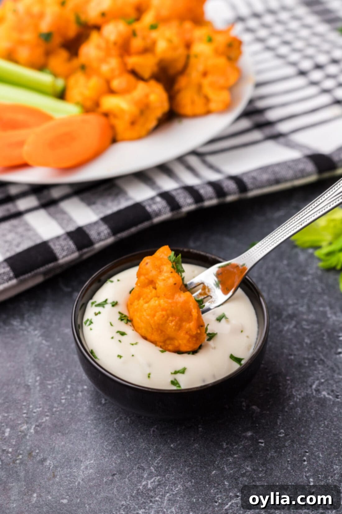Buffalo Cauliflower being dipped into ranch 