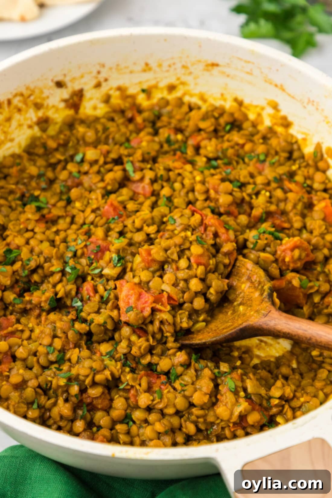 Skillet of Lentil Curry with a spoon in it