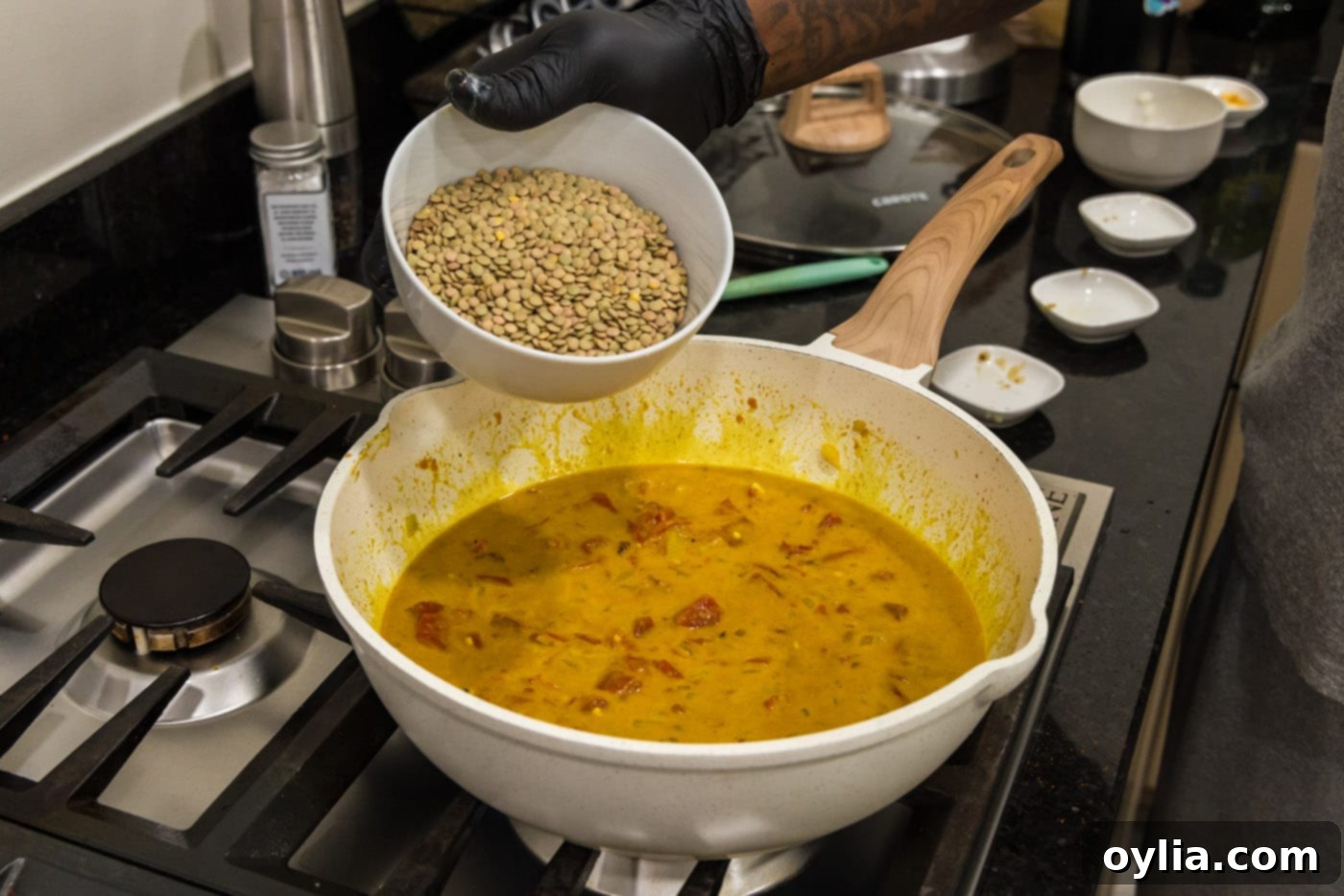 adding brown lentils to curry sauce