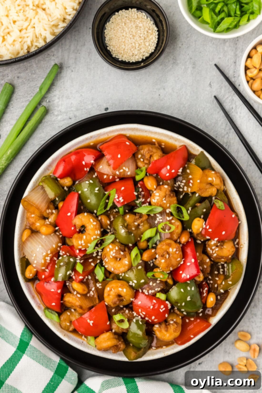 Plate of Kung Pao Shrimp with rice and peanuts on the side