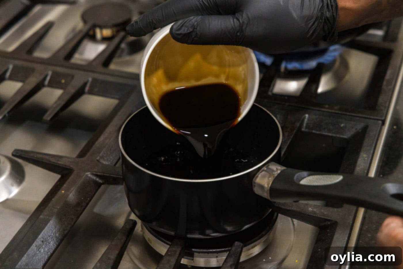 pouring soy sauce into a saucepan
