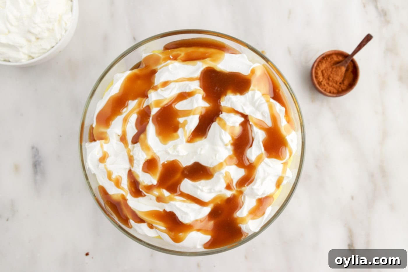 Whipped cream and caramel sauce on top of gingerbread trifle.