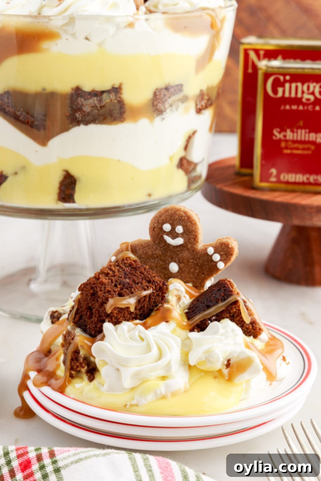 A slice of Gingerbread Trifle served on a white plate, showcasing all the delicious layers.