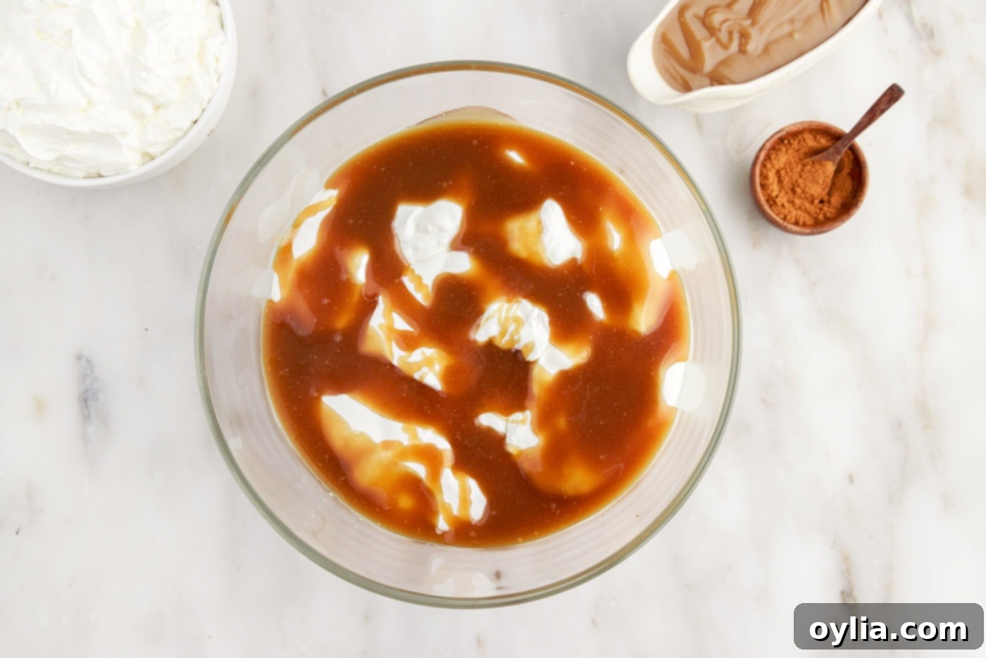 A generous drizzle of rich caramel sauce over the whipped cream layer in the Gingerbread Trifle.