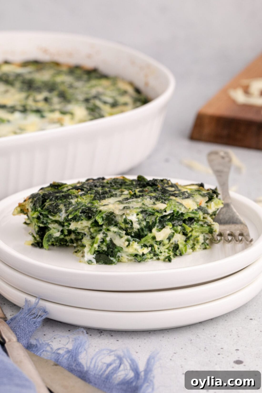 A generous serving of Spinach Souffle perfectly plated, showing its vibrant green and cheesy interior, ready to be enjoyed.