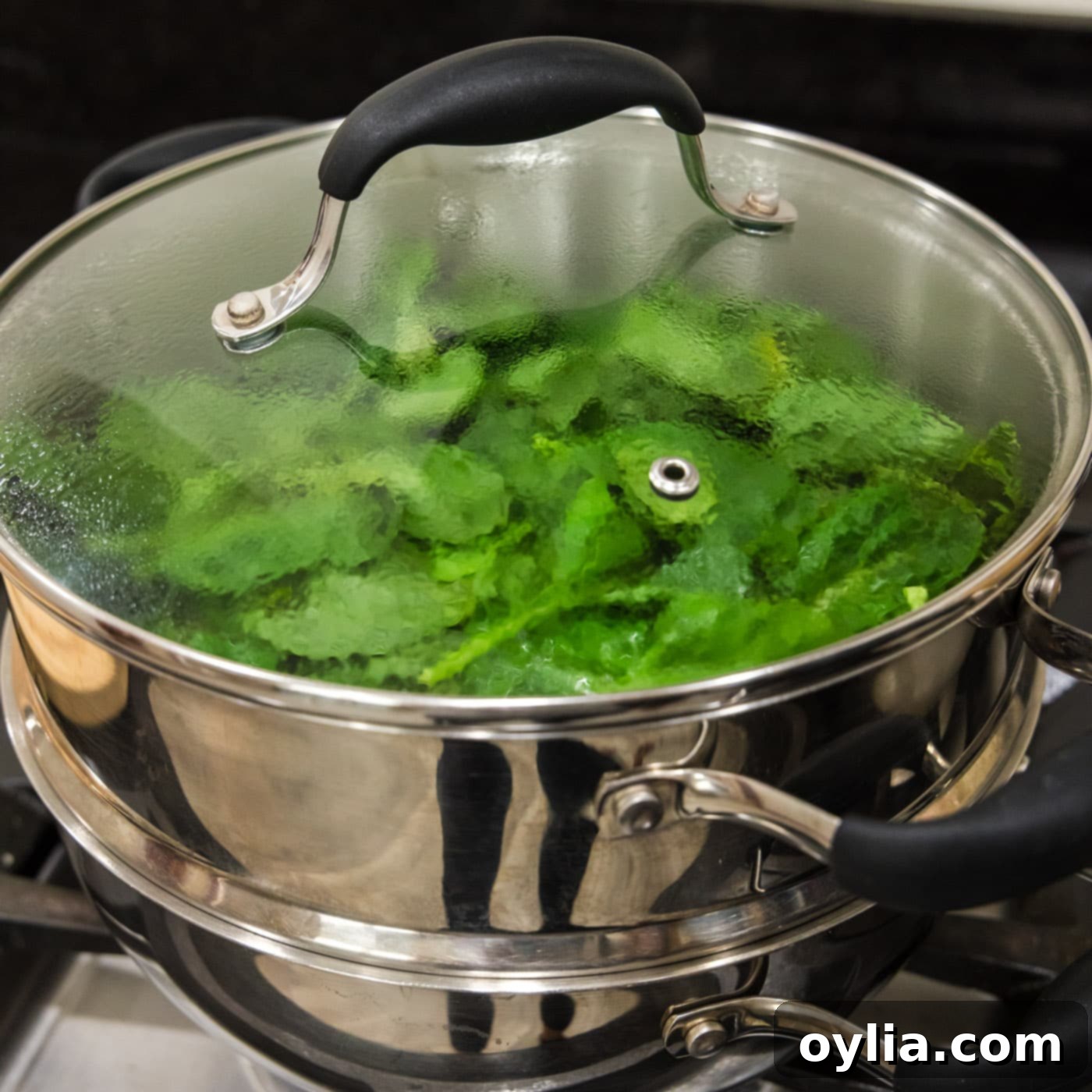 steaming spinach in a steam pot, showing wilted leaves