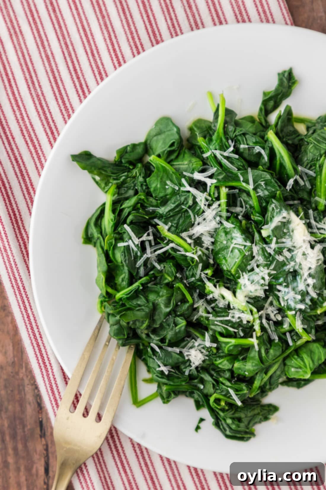 Nutrient-Rich Steamed Spinach 8 Close up photo of a plate of Steamed Spinach with a fork, ready to be eaten