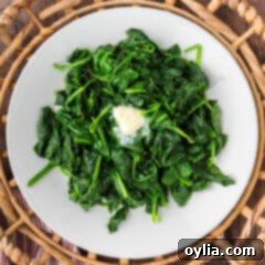 Nutrient-Rich Steamed Spinach 9 Steamed Spinach on a plate with a pat of butter melting on top