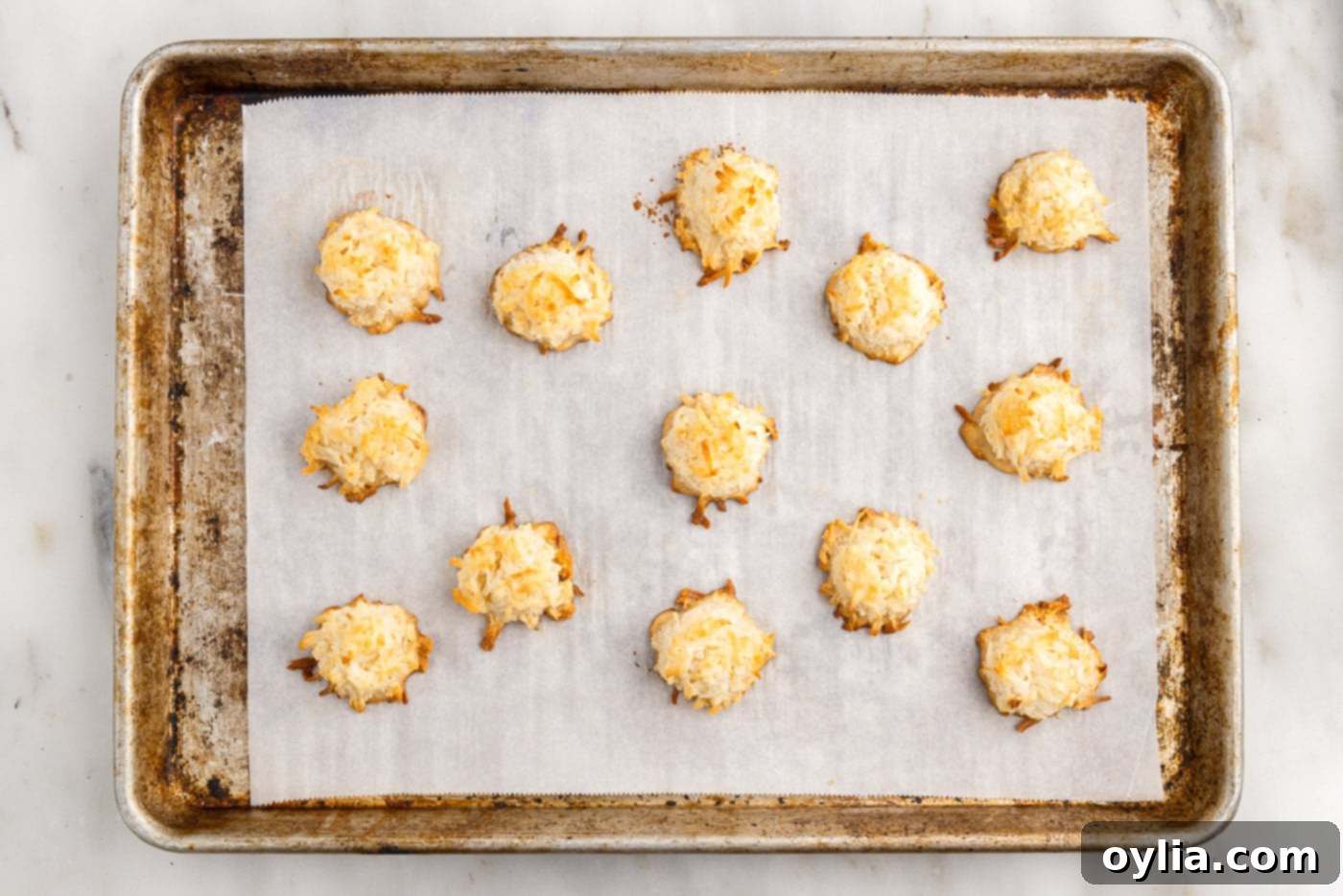 Easy baked coconut macaroons on a cookie sheet, perfectly golden