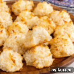 Coconut Macaroon Delights 14 Coconut Macaroons on a wooden platter with a bite taken out of one
