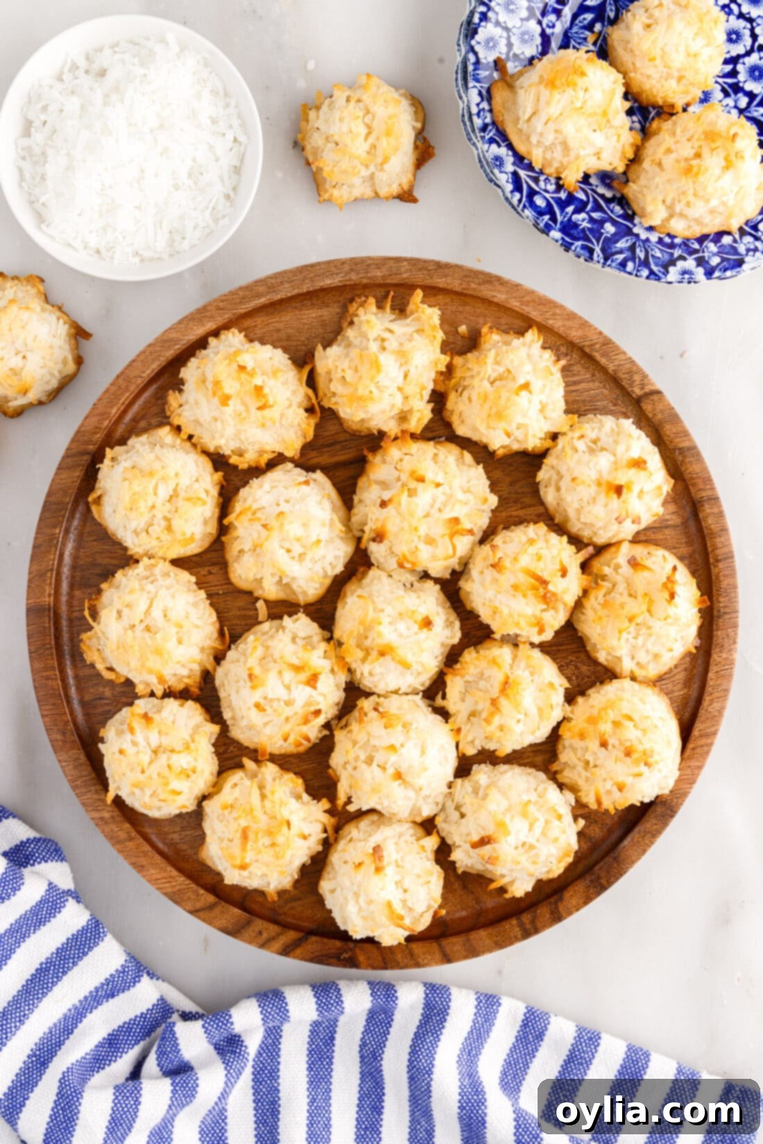 Coconut Macaroon Delights 3 Golden Coconut Macaroons arranged on a rustic wooden platter