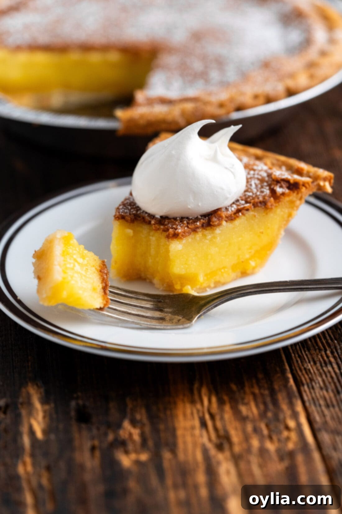 Slice of Chess Pie on a plate with a bite on a fork
