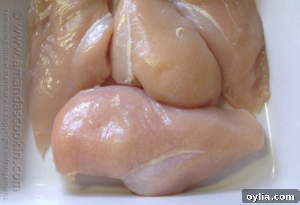 A close up photo of raw chicken breasts.