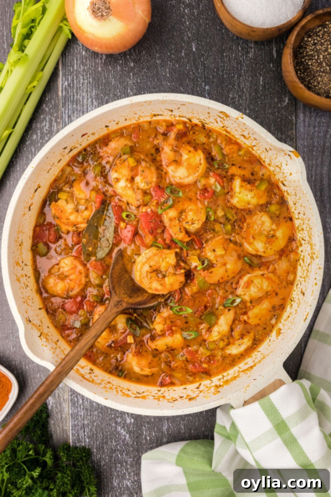 Skillet of Shrimp Creole with a spoon in it