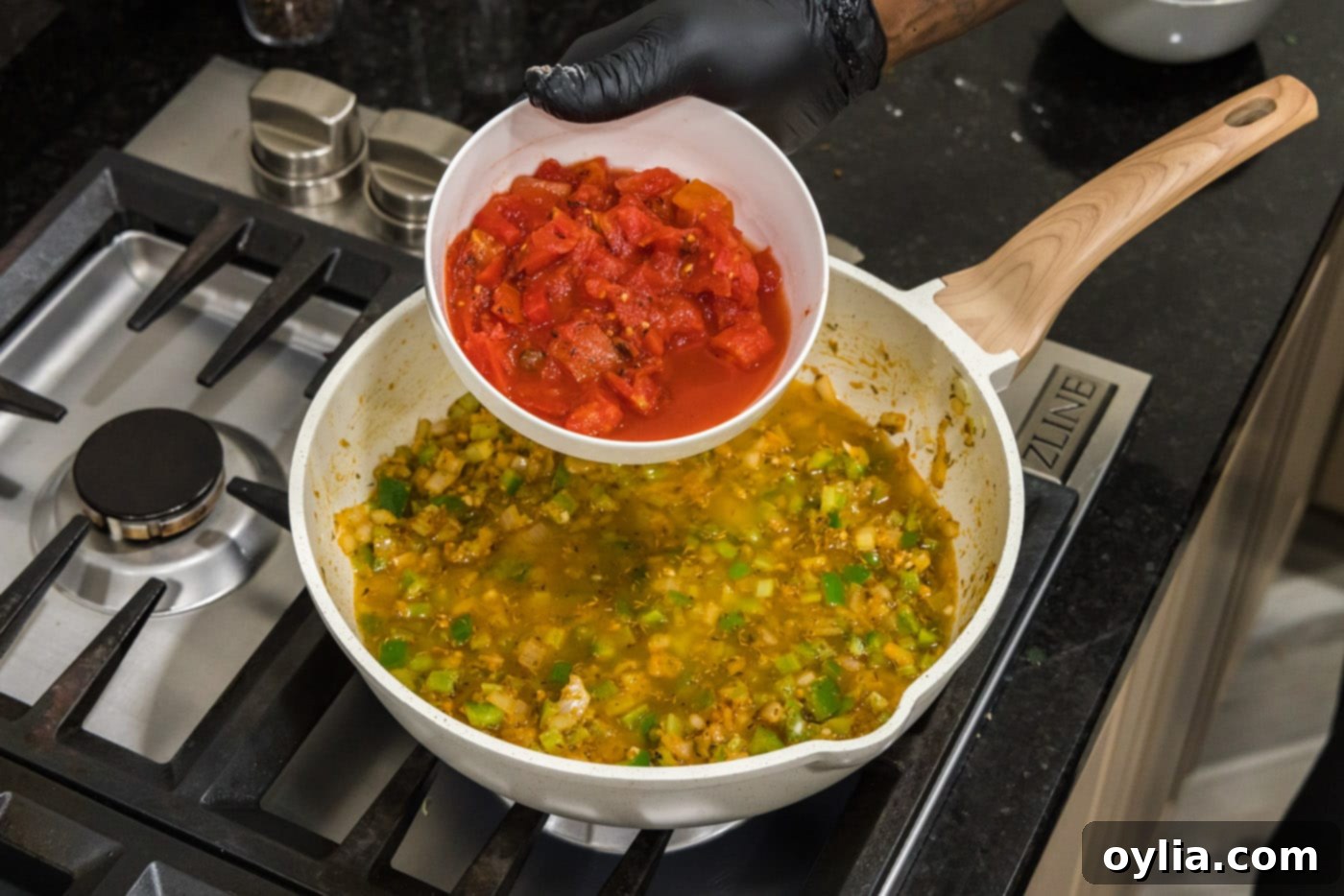 adding fire roasted tomatoes to shrimp creole