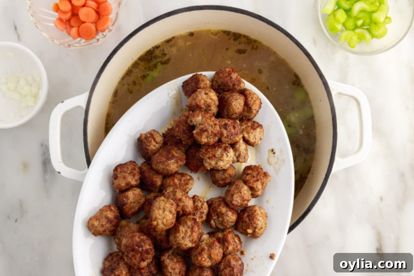adding meatballs to Italian wedding soup
