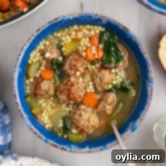 Bowl of Italian Wedding Soup with a spoon in it