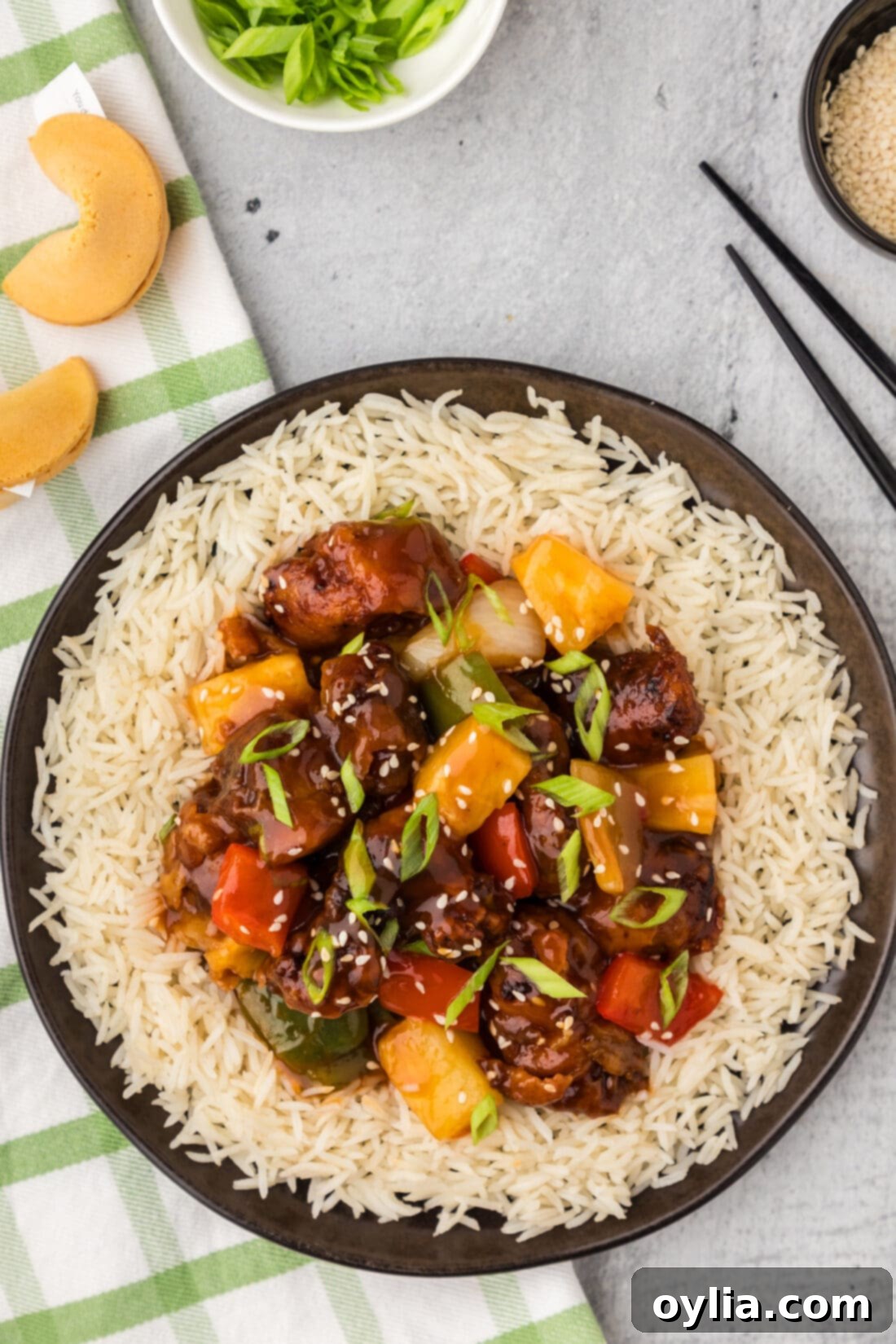 Crispy Sweet Sour Pork 2 Sweet and Sour Pork served on a plate over rice, garnished with green onions