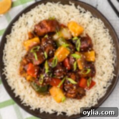Crispy Sweet Sour Pork 19 Overhead photo of Sweet and Sour Pork served over rice, garnished