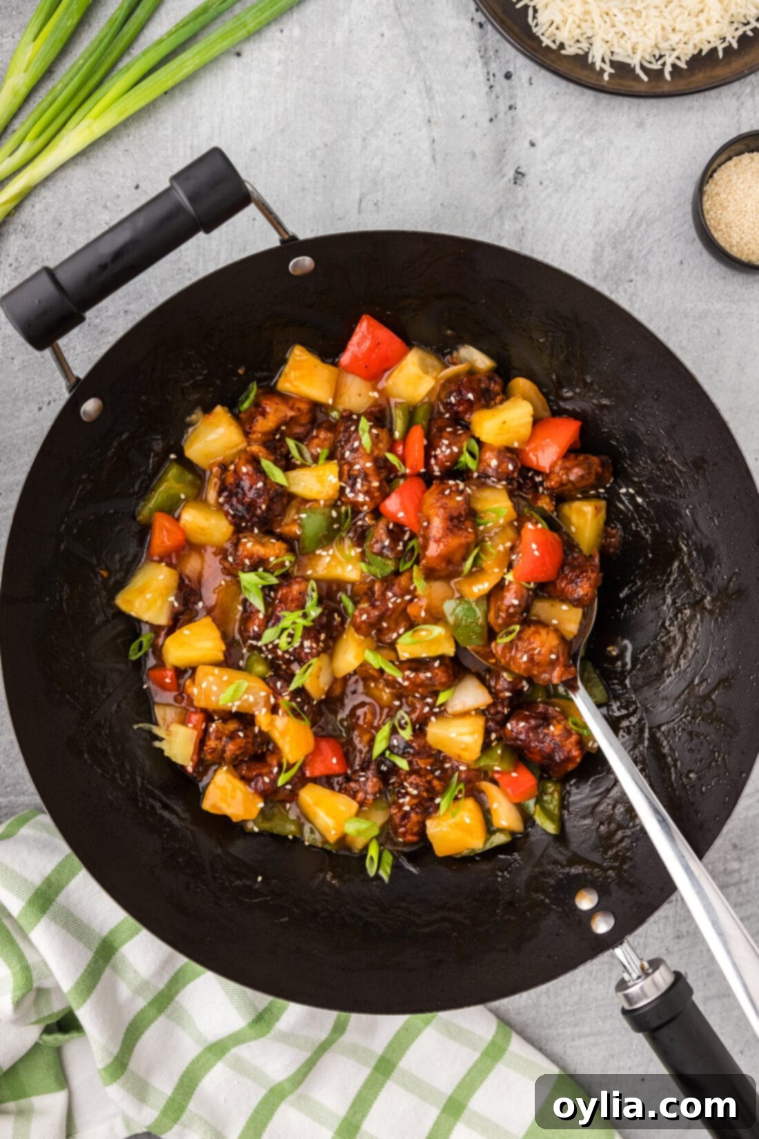 Crispy Sweet Sour Pork 3 Wok filled with homemade Sweet and Sour Pork, with a serving spoon