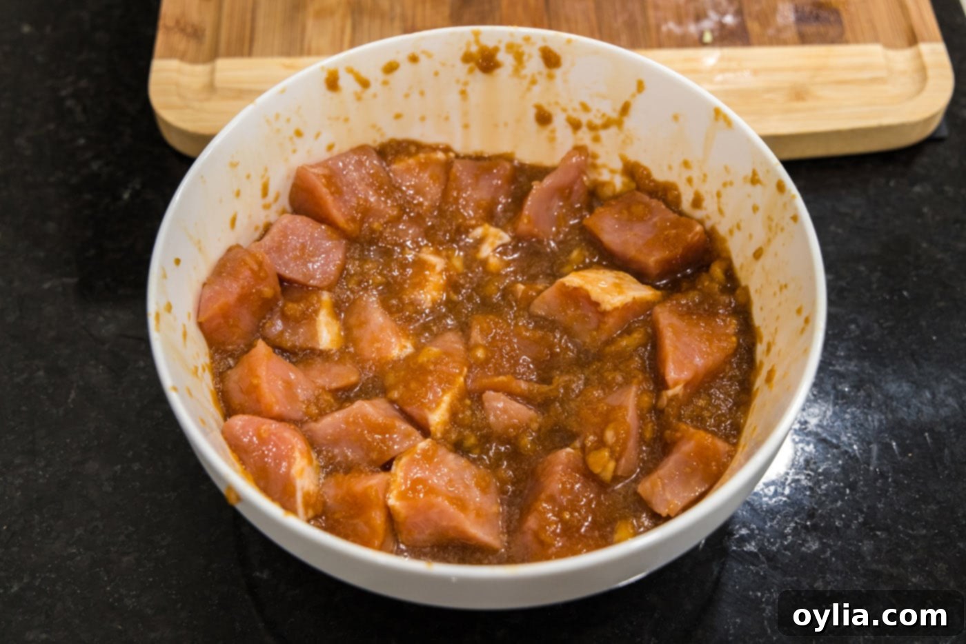 Pork cubes marinating in a bowl for sweet and sour pork stir-fry