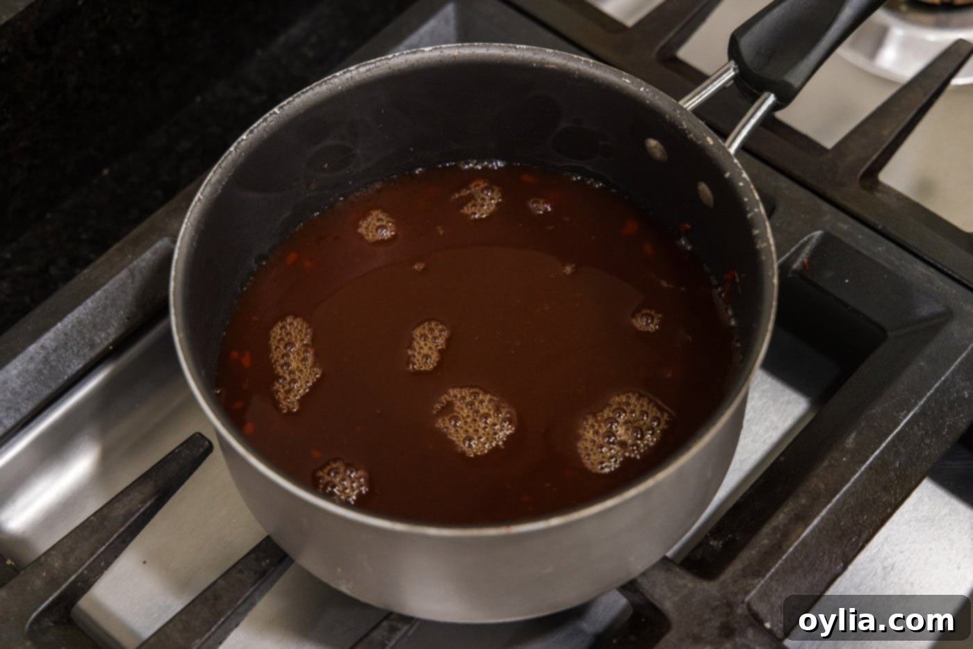 Sweet and sour sauce simmering in a saucepan