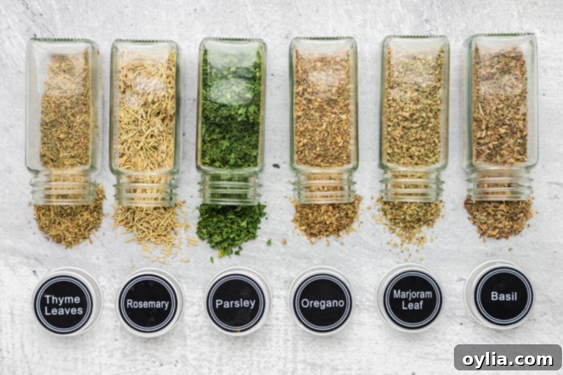 Classic Italian Herb Blend 4 Individual bowls of dried oregano, basil, thyme, rosemary, marjoram, and parsley, laid out as ingredients for Italian seasoning.