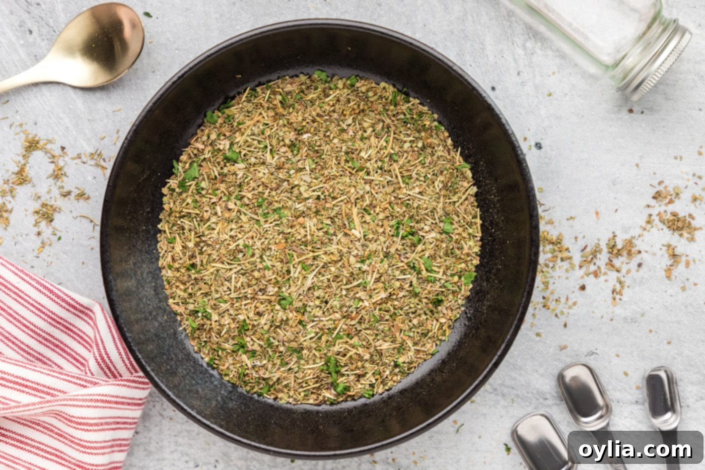 A perfectly blended mix of homemade Italian seasoning in a mixing bowl after combining all the dried herbs.