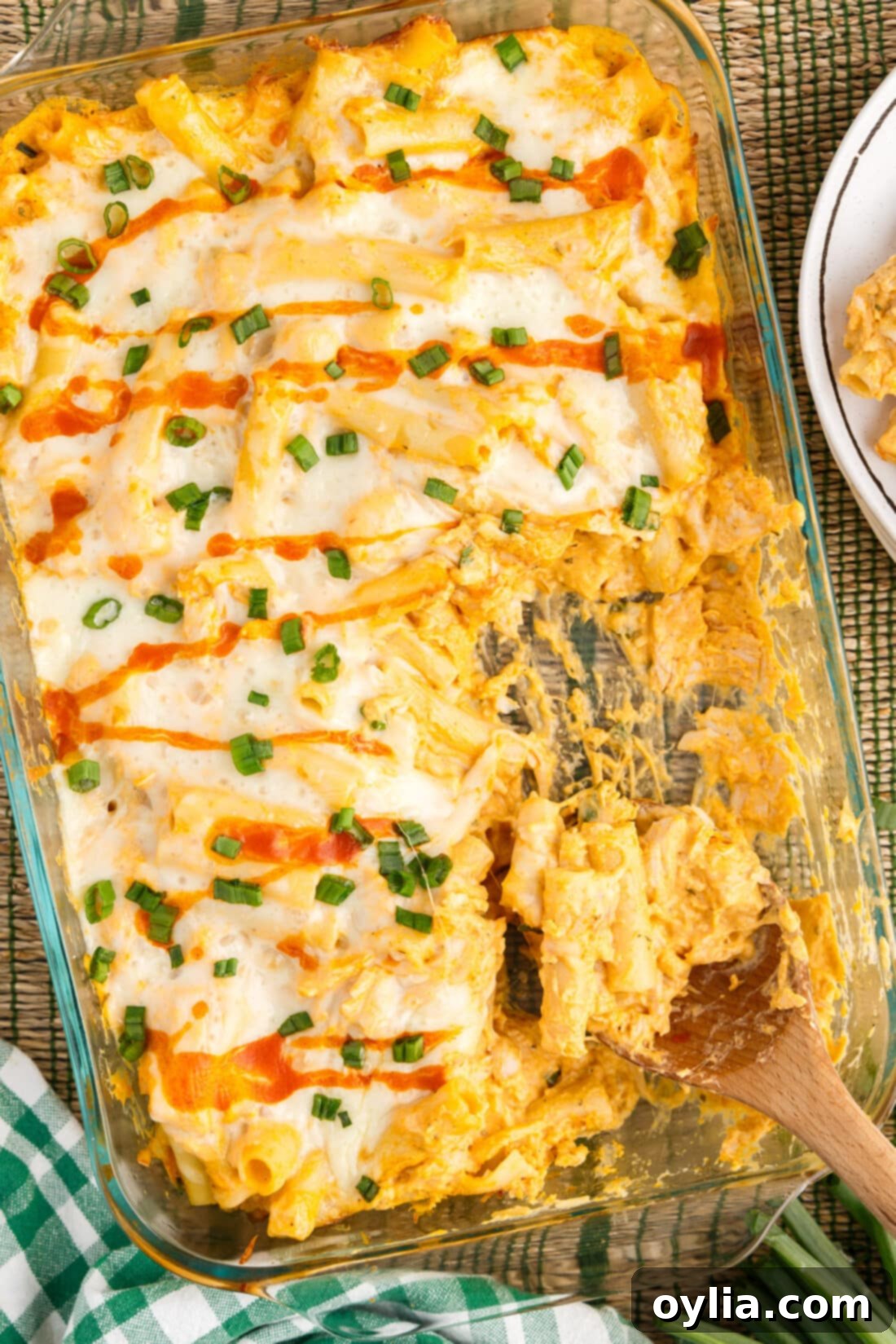 Dish of Buffalo Chicken Casserole with a spoon in it, showcasing its creamy, cheesy texture.
