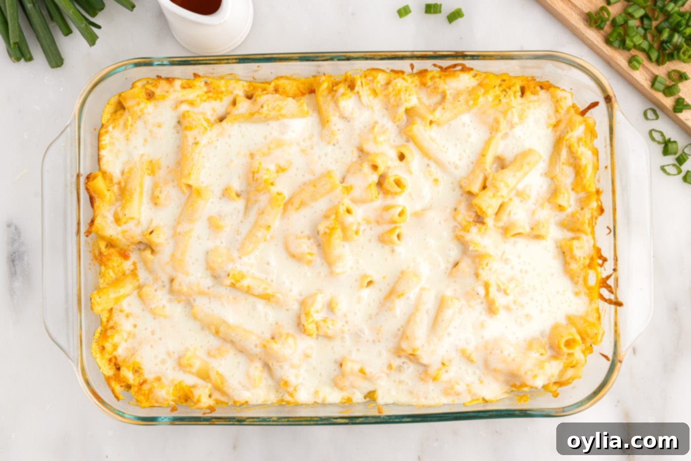 Freshly baked buffalo chicken casserole, hot and bubbly with melted cheese, just out of the oven.