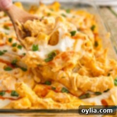 Close up photo of a spoonful of creamy, cheesy Buffalo Chicken Casserole