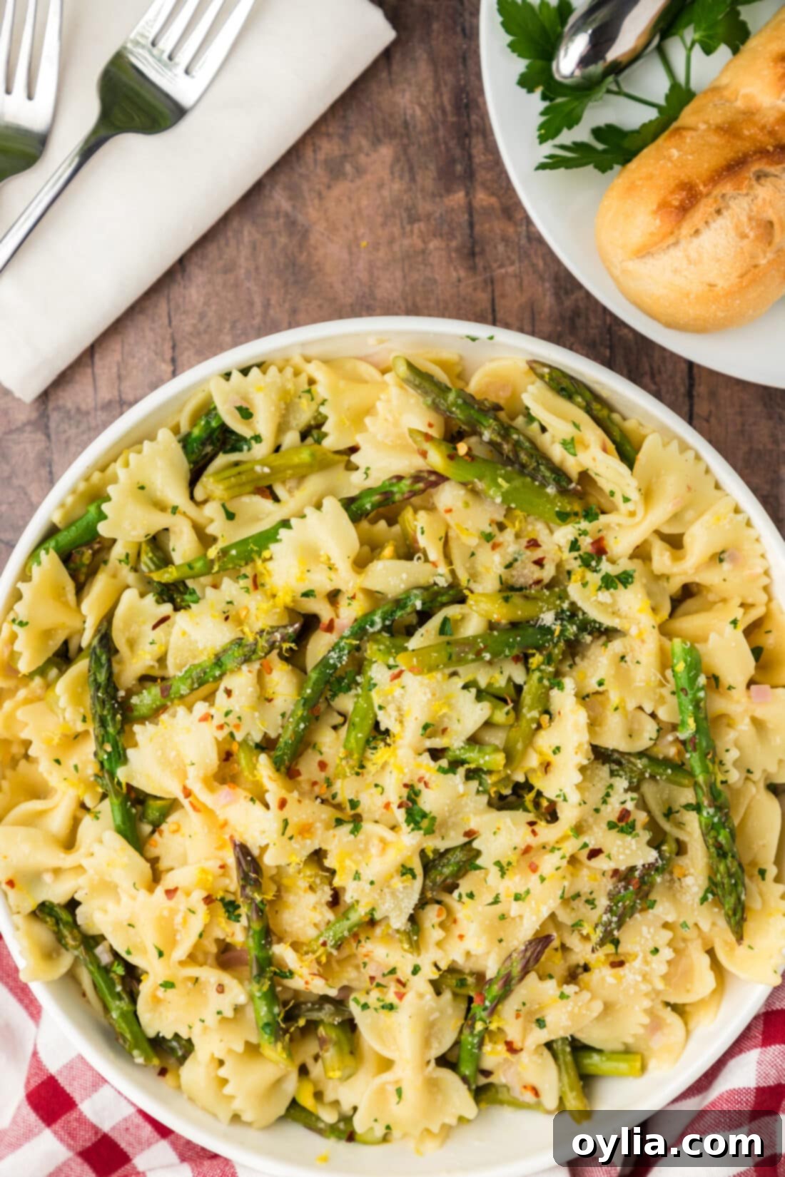 Bowl of Asparagus Pasta with bread on the side, highlighting the fresh ingredients and rich sauce.