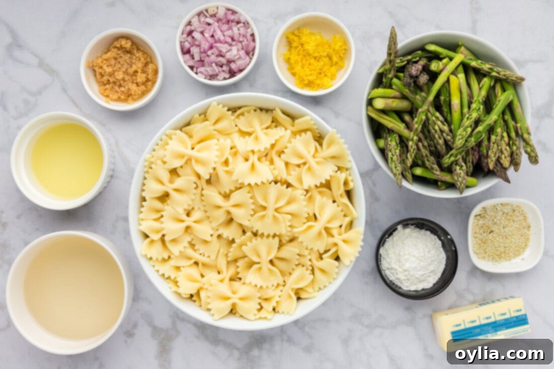 Ingredients for Asparagus Pasta, including fresh asparagus, pasta, lemon, and seasonings.
