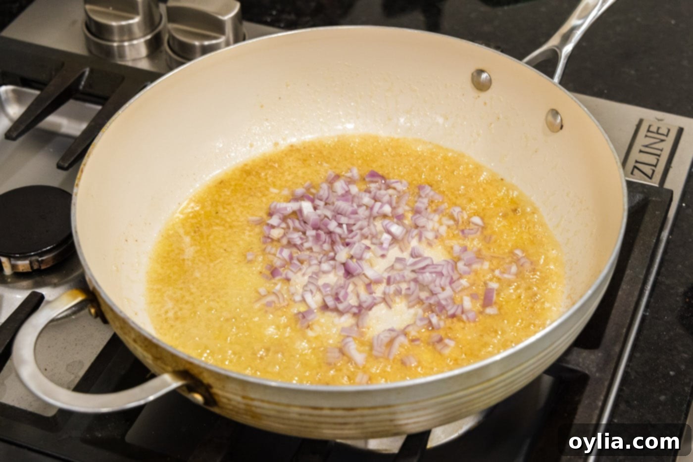 Melted butter, minced garlic, and shallots gently sizzling in a skillet, creating a fragrant base for the sauce.