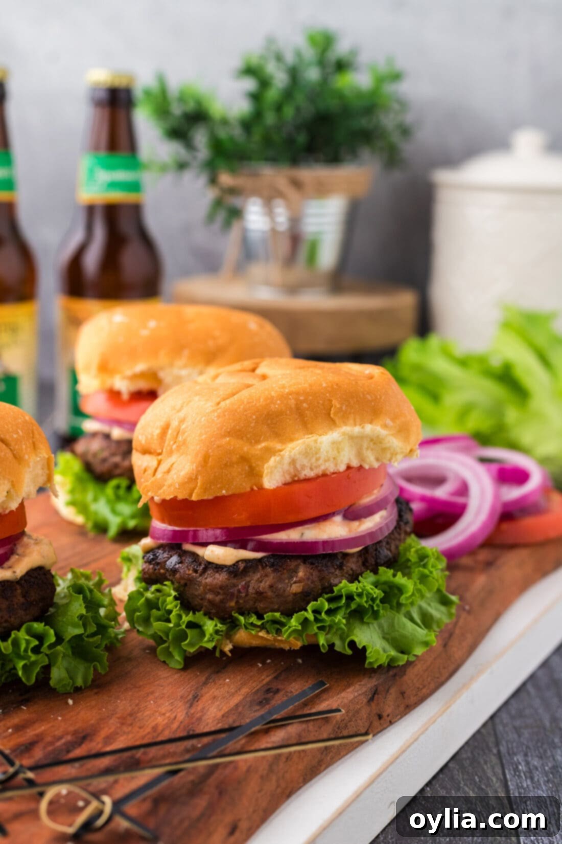 Buffalo Burger on a wooden board with more burgers behind it