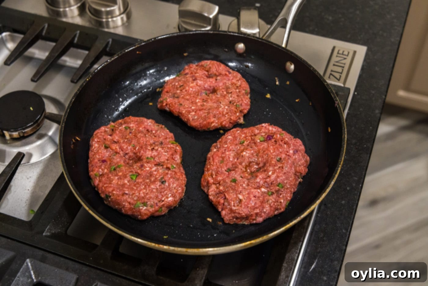 cooking bison burgers in a skillet