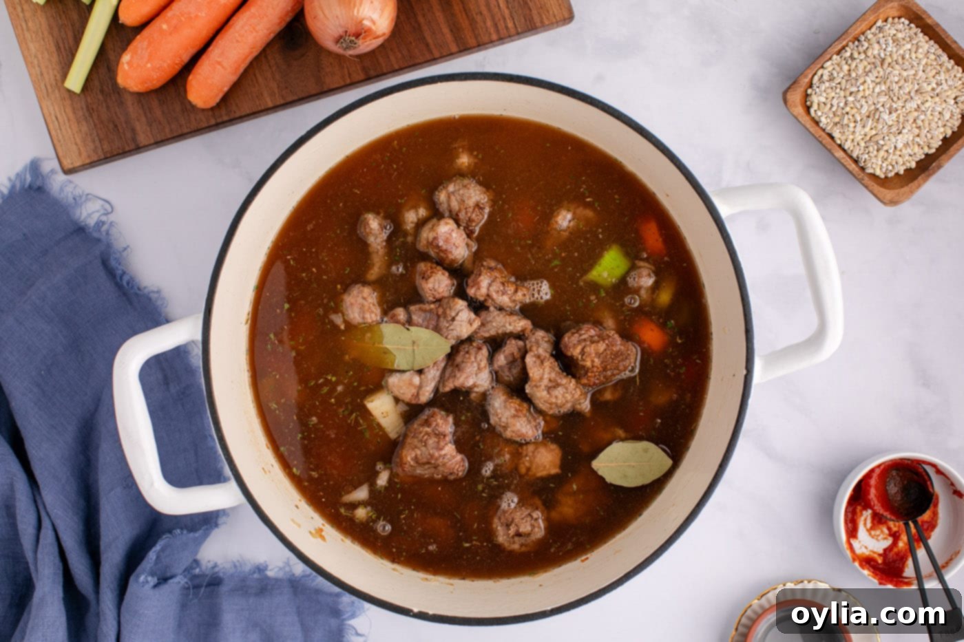 beef barley soup with beef broth in a stock pot