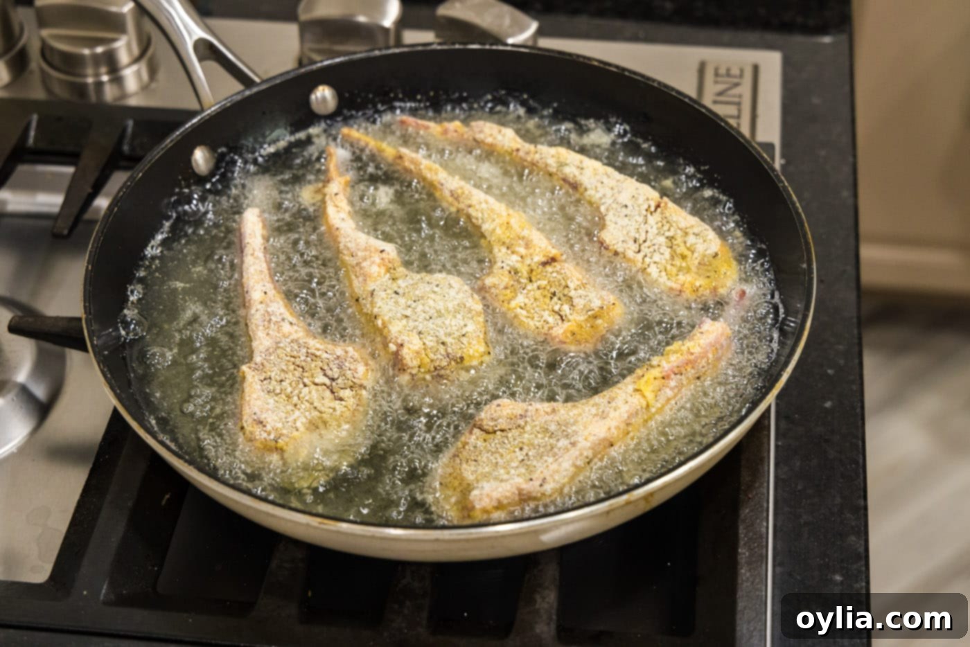 dredged lamb chops frying in oil