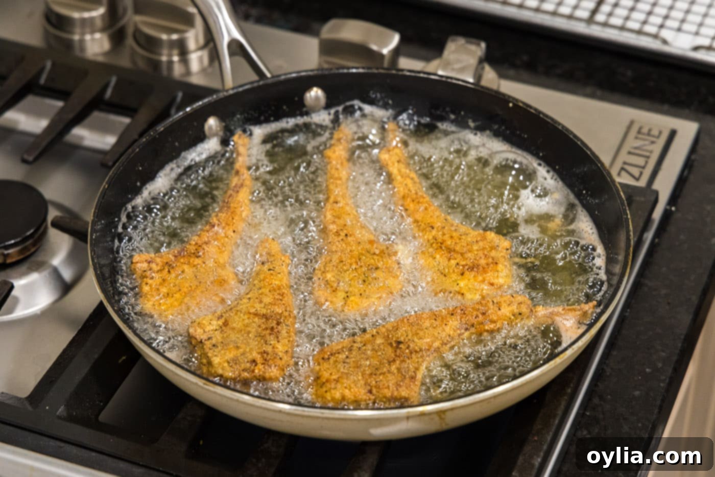 fried lamb chops in a skillet of oil