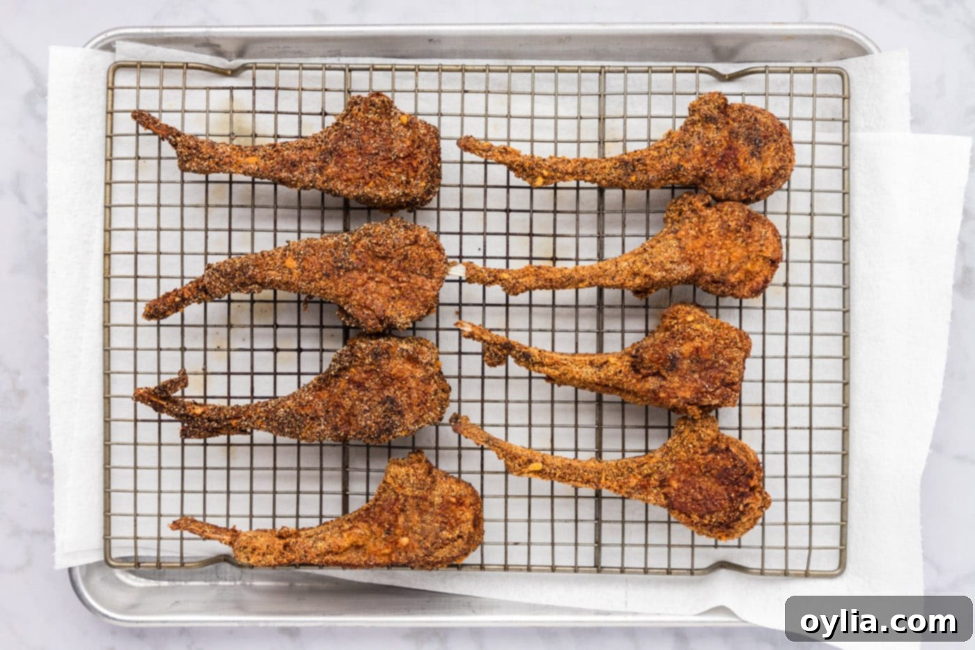 golden crusted fried lamb chops on a wire rack